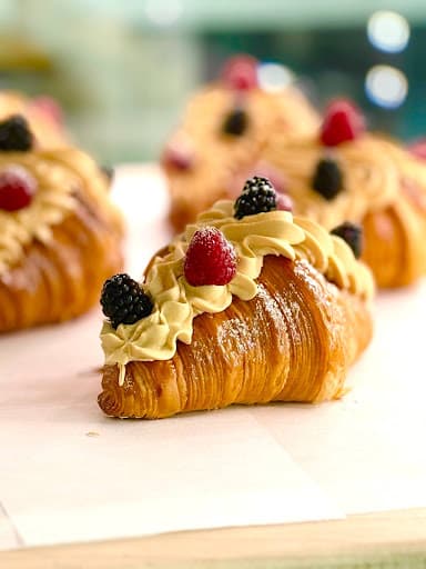 A filled croissant made at What Coffee