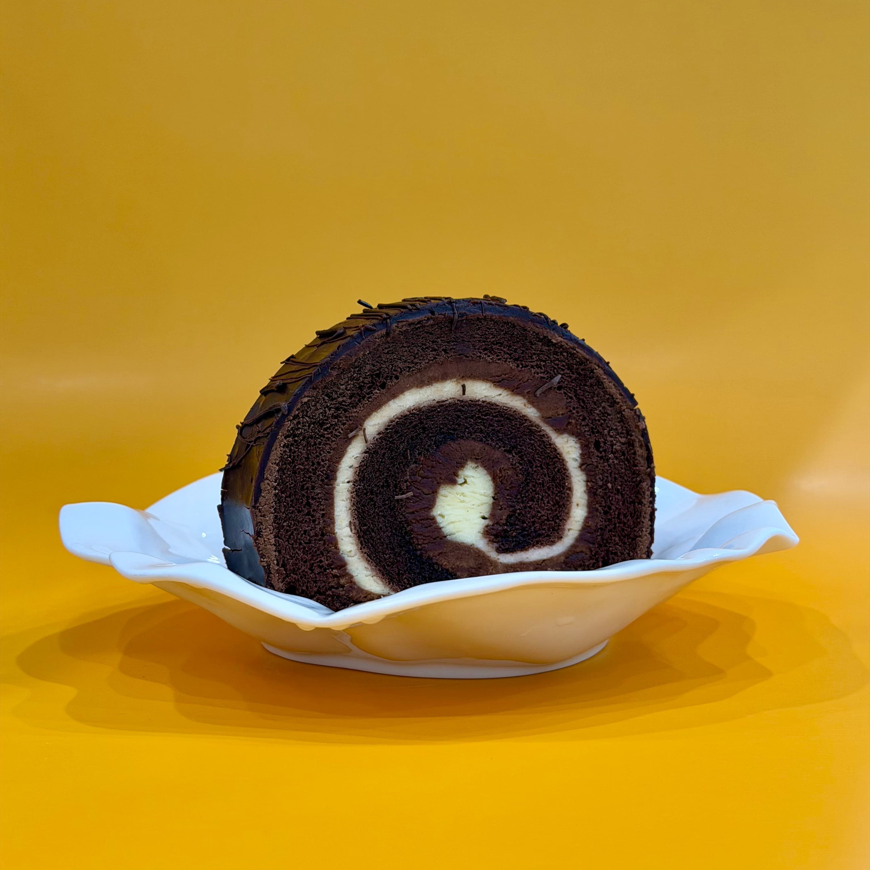 Chocolate Roll Cake - Soft sponge rolled with rich chocolate cream—sliceable and indulgent.