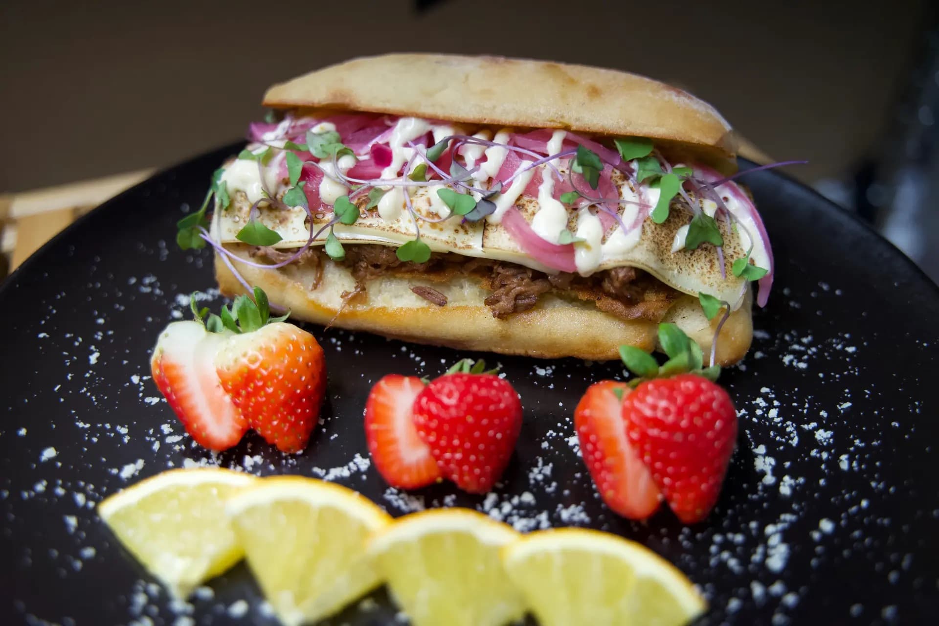 The San Francisco - Tender, herb-roasted beef stacked high with rich cheese and juicy tomato slices, perfectly paired with a refreshing garden salad and fresh seasonal fruits.